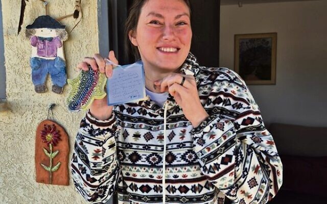 Kfar Aza resident Yaktarina Horwitz with her hamsa from Sydney. Kfar Aza resident Yaktarina Horwitz with her hamsa from Sydney.
