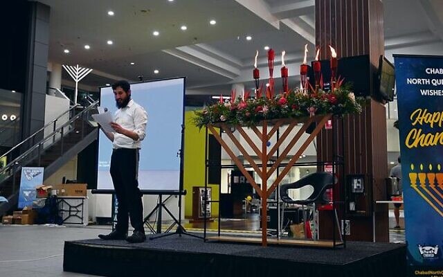 Chabad North Queensland's Rabbi Ari Rubin with the flower menorah in Cairns.Photo: supplied Chabad North Queensland's Rabbi Ari Rubin with the flower menorah in Cairns.Photo: supplied