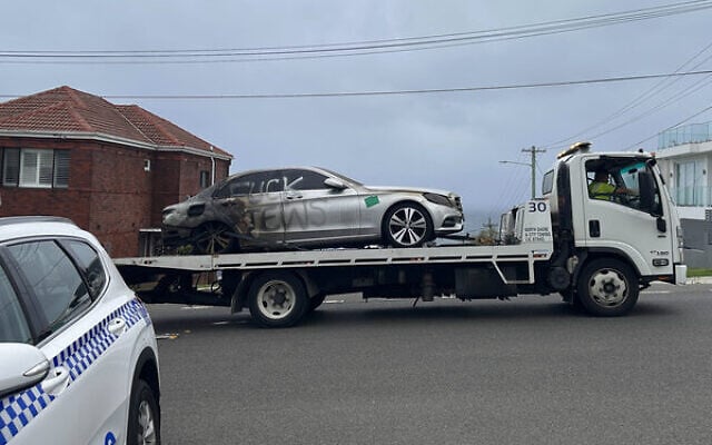 A burnt car with antisemitic graffiti in Sydney's Dover Heights on January 17. Photo: AAP Image/Neve Brissendeni A burnt car with antisemitic graffiti in Sydney's Dover Heights on January 17. Photo: AAP Image/Neve Brissendeni