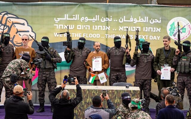 Israeli captives, from left to the right, Ohad Ben Ami, Eli Sharabi and Or Levy, who have been held hostage by Hamas in Gaza since October 7, 2023, onstage before being handed over to the Red Cross in Deir al-Balah, central Gaza Strip, Saturday Feb. 8, 2025. (AP Photo/Abdel Kareem Hana) Israeli captives, from left to the right, Ohad Ben Ami, Eli Sharabi and Or Levy, who have been held hostage by Hamas in Gaza since October 7, 2023, onstage before being handed over to the Red Cross in Deir al-Balah, central Gaza Strip, Saturday Feb. 8, 2025. (AP Photo/Abdel Kareem Hana)
