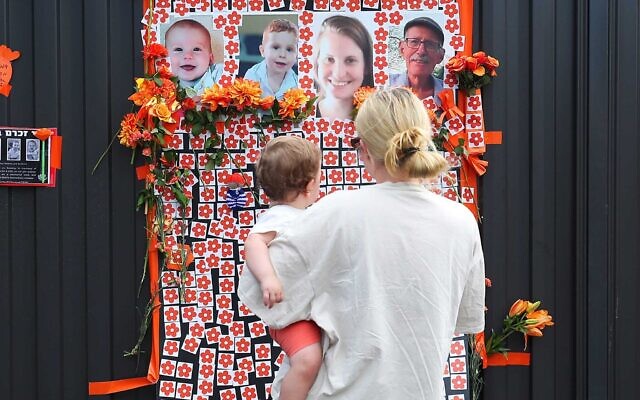 A mother and child at the memorial to the murdered hostages at Beth Weizmann. Photo: Peter Haskin. A mother and child at the memorial to the murdered hostages at Beth Weizmann. Photo: Peter Haskin.