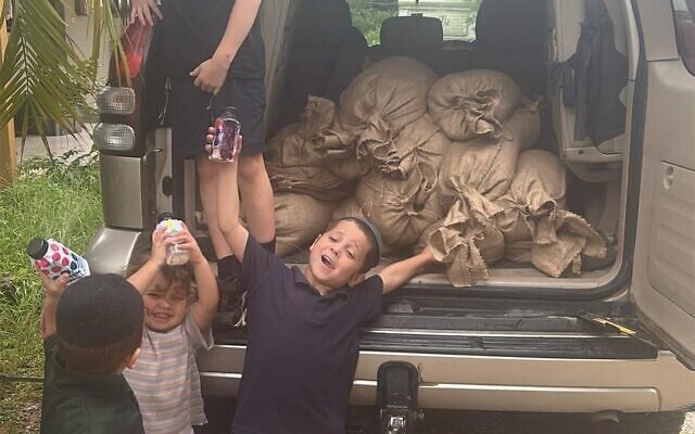 Young Chabad members help load essentials for Jewish families marooned by floods in Byron Shire. Young Chabad members help load essentials for Jewish families marooned by floods in Byron Shire.