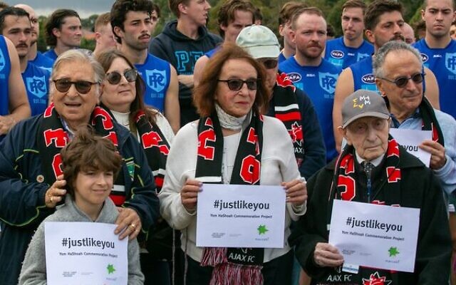 Holocaust survivors and their grandchildren (front) during the pre-game ceremony commemorating Yom Hashoah. Photo: Tuvsday Photography Holocaust survivors and their grandchildren (front) during the pre-game ceremony commemorating Yom Hashoah. Photo: Tuvsday Photography