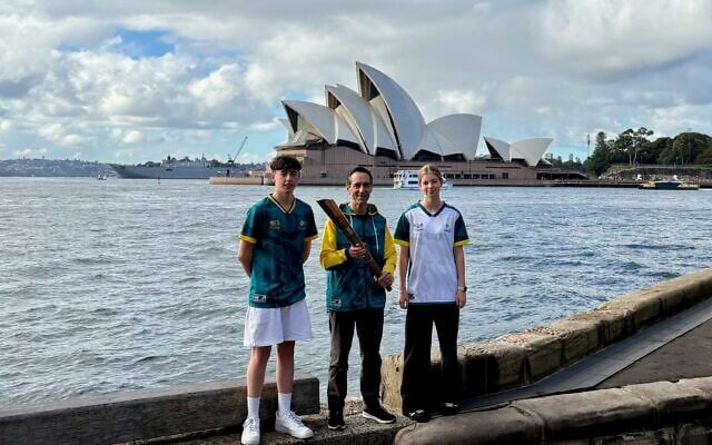 Ethan Hammerschlag, Barry Lipp and Mia Goodridge with the Maccabiah torch across from the Sydney Opera House on May 11. Photo: Maccabi Australia Ethan Hammerschlag, Barry Lipp and Mia Goodridge with the Maccabiah torch across from the Sydney Opera House on May 11. Photo: Maccabi Australia