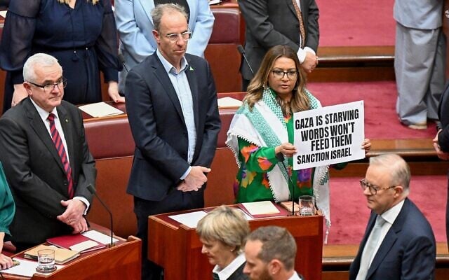 Greens Senator Mehreen Faruqi holds a placard in the Senate chamber for the opening of the 48th Federal Parliament in Canberra on July 22, 2025. Photo: Lukas Coch/AAP Image via AP, via Times of Israel Greens Senator Mehreen Faruqi holds a placard in the Senate chamber for the opening of the 48th Federal Parliament in Canberra on July 22, 2025. Photo: Lukas Coch/AAP Image via AP, via Times of Israel