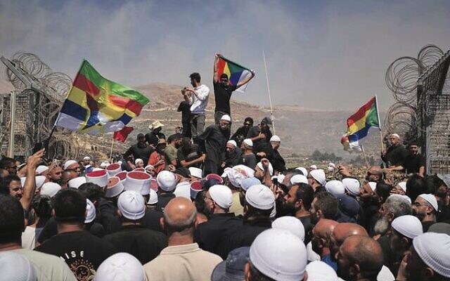 Druze from Syria and Israel protest on the Israeli-Syrian border on
July 16. Photo: Times of Israel. Druze from Syria and Israel protest on the Israeli-Syrian border on
July 16. Photo: Times of Israel.