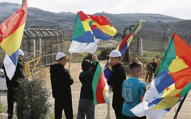 Druze boys hold flags in the border village of Majdal Shams on the Israeli side of the Golan Heights.
Photo: TOI Druze boys hold flags in the border village of Majdal Shams on the Israeli side of the Golan Heights.
Photo: TOI