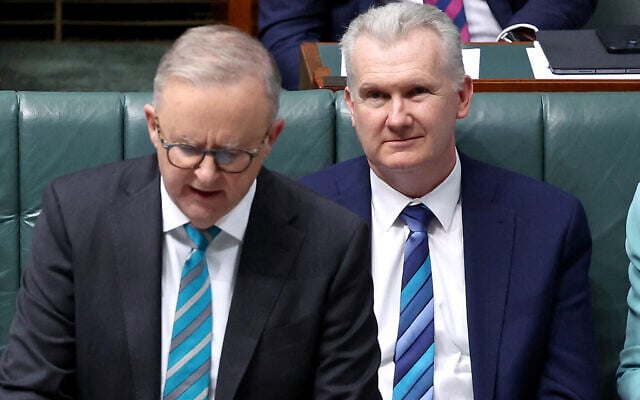 This picture taken on June 27, 2024 shows Australian Home Affairs Minister Tony Burke (R) listening to Australian Prime Minister Anthony Albanese speaking at the House of Representatives at Parliament House in Canberra. (DAVID GRAY / AFP) This picture taken on June 27, 2024 shows Australian Home Affairs Minister Tony Burke (R) listening to Australian Prime Minister Anthony Albanese speaking at the House of Representatives at Parliament House in Canberra. (DAVID GRAY / AFP)
