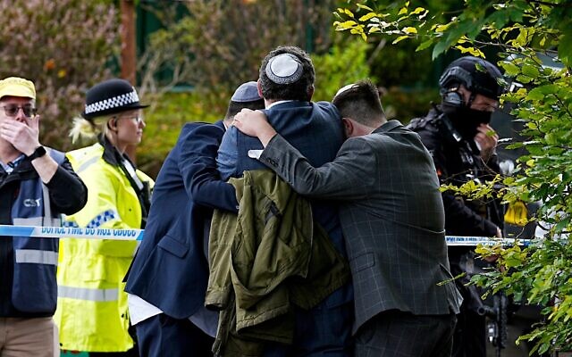 Members of the Jewish community comfort each other near the Heaton Park Hebrew Congregation synagogue, in Crumpsall, Manchester, England, October 2, 2025. Photo: Peter Byrne/PA via AP Members of the Jewish community comfort each other near the Heaton Park Hebrew Congregation synagogue, in Crumpsall, Manchester, England, October 2, 2025. Photo: Peter Byrne/PA via AP