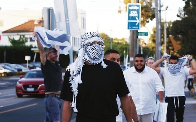 A pro-Israel supporter stands defiant against Pro-Palestinian supporters on Hawthorn Road, Caulfield in 2023. Photo: Peter Haskin Photography. A pro-Israel supporter stands defiant against Pro-Palestinian supporters on Hawthorn Road, Caulfield in 2023. Photo: Peter Haskin Photography.