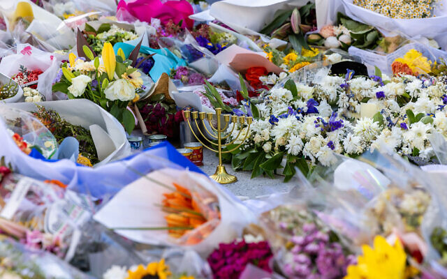 A chanukiah sits amid the floral tributes at Bondi. Photo: Michael Gara/Facebook A chanukiah sits amid the floral tributes at Bondi. Photo: Michael Gara/Facebook