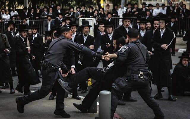Police detain an ultra-Orthodox man during a protest against Charedi enlistment outside a military recruitment center in Jerusalem, November 12, 2025. Photo: Chaim Goldberg/Flash90 Police detain an ultra-Orthodox man during a protest against Charedi enlistment outside a military recruitment center in Jerusalem, November 12, 2025. Photo: Chaim Goldberg/Flash90