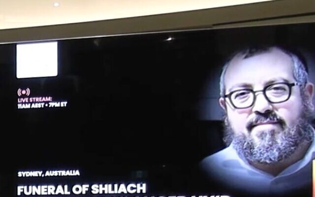 An image of Rabbi Eli Schlanger is displayed on a big screen at his funeral service at Chabad of Bondi shule on December 17. An image of Rabbi Eli Schlanger is displayed on a big screen at his funeral service at Chabad of Bondi shule on December 17.