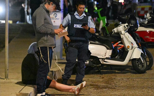 A policeman works at the scene of a shooting attack at a Chanukah event at Bondi Beach in Sydney. Photo: Saeed KHAN/AFP A policeman works at the scene of a shooting attack at a Chanukah event at Bondi Beach in Sydney. Photo: Saeed KHAN/AFP