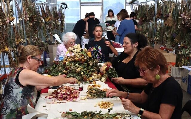 Volunteers sort through flowers left in tribute at Bondi Pavilion for preservation by the Sydney Jewish Museum. Photo: Supplied Volunteers sort through flowers left in tribute at Bondi Pavilion for preservation by the Sydney Jewish Museum. Photo: Supplied
