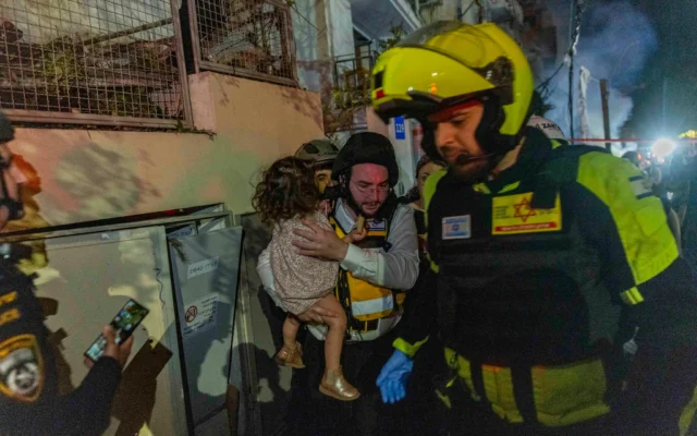 Israeli security and rescue forces at the scene where a ballistic missile fired from Iran hit an apartment building in Tel Aviv on February 28, 2026. (Chaim Goldberg/Flash90) Israeli security and rescue forces at the scene where a ballistic missile fired from Iran hit an apartment building in Tel Aviv on February 28, 2026. (Chaim Goldberg/Flash90)