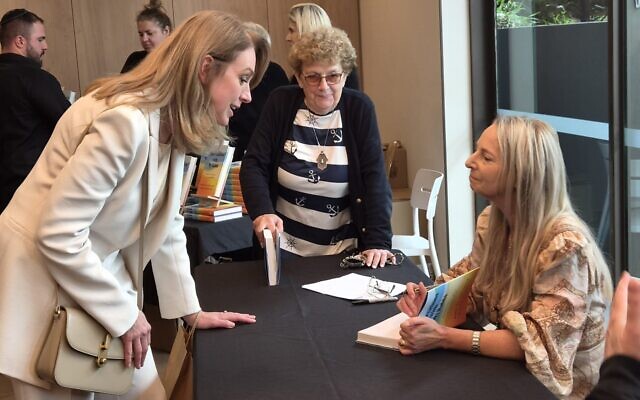 Author Nikki Goldstein (right) signs a copy of 'Conversations with My Rabbi', the book she co-wrote with Rabbi Eli Schlanger, for NSW Opposition Leader Kellie Sloane. Author Nikki Goldstein (right) signs a copy of 'Conversations with My Rabbi', the book she co-wrote with Rabbi Eli Schlanger, for NSW Opposition Leader Kellie Sloane.