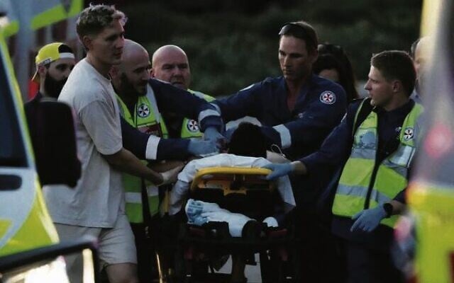 A person is aided by paramedics after the shooting at a Chanukah event at Bondi Beach. Photo: AP Photo/Mark Baker A person is aided by paramedics after the shooting at a Chanukah event at Bondi Beach. Photo: AP Photo/Mark Baker