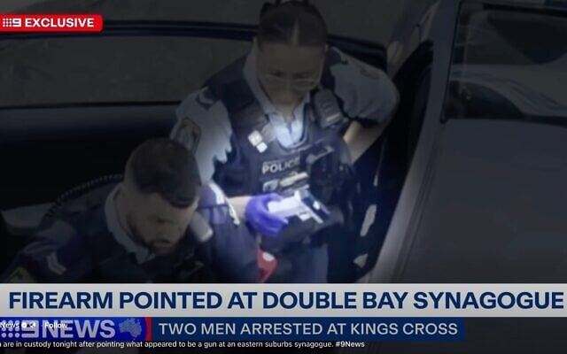 Police with the imitation firearm. Photo: Screenshot/Channel 9 Police with the imitation firearm. Photo: Screenshot/Channel 9