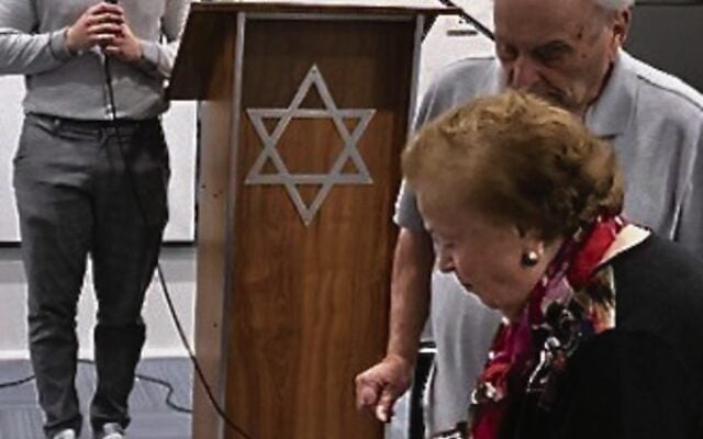 Serena Feldman lighting a candle at a 2022 Yom Hashoah service at COA. Serena Feldman lighting a candle at a 2022 Yom Hashoah service at COA.
