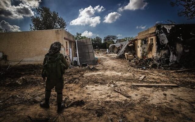 An IDF soldier stands amid destruction caused by Hamas terrorists in Kibbutz Kfar Aza, October 15, 2023. Photo: Chaim Goldberg/Flash90 An IDF soldier stands amid destruction caused by Hamas terrorists in Kibbutz Kfar Aza, October 15, 2023. Photo: Chaim Goldberg/Flash90