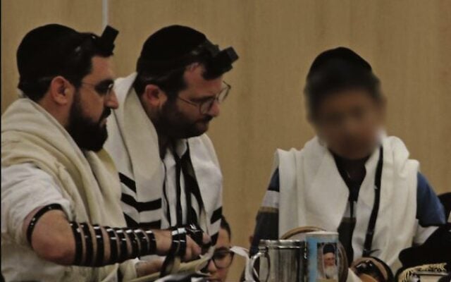 Uriel called to the Torah with his teacher, Rabbi Yosef Chaim.
Photo: Supplied Uriel called to the Torah with his teacher, Rabbi Yosef Chaim.
Photo: Supplied