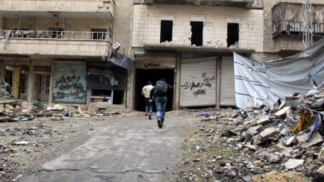 رجال يركضون باتجاه مأوى في حي صلاح الدين في حلب 27 يناير (شهباء برس/ أ ف ب)