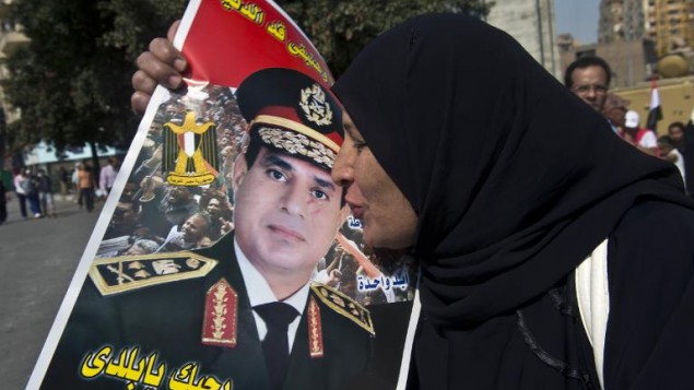 سيدة مصرية تقبل صورة السيسي في ميدان التحرير 6 اوكتوبر 2013 (أرشيف خالد دسوقي أ ف ب)