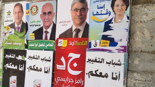 لائحة اعلانات مع صور المرشحين لرئاسة بلدية الناصرة 2013 (الحانان ميلر/ طاقم تايمز أوف اسرائيل)