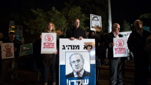 المتظاهرين، بعضهم أقارب للذين قتلوا على يد فلسطينيين، في مظاهرة احتجاجا على الدفعة القادمة بالقرب من مقر رئيس الوزراء في القدس في 28 ديسمبر 2013 لافتة تظهر رسم بنيامين نتنياهو مكتوب باللغة العبرية: "ليس زعيما،  كاذب ". ( Flash90)