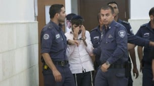 رجال الشرطة يرافقون يوسف حاييم بن دافيد, أحد المشتبه بهم اليهود في قتل القاصر محمد ابو خضير في المحكمة القطرية في القدس 6 أغسطس (يوناتان سنايدل/ فلاش 90)