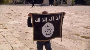A youngster holding an IS flag on the Temple Mount in Jerusalem (photo credit: Facebook)