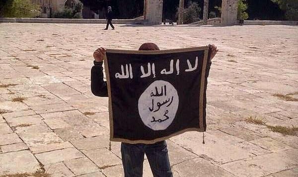 A youngster holding an IS flag on the Temple Mount in Jerusalem (photo credit: Facebook)