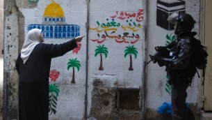امرأة فلسطينية تصرخ في وجه رجل شرطة إسرائيلية في البلدة القديمة في القدس  30 أكتوبر عام 2014 بعد ان اغلقت السلطات الإسرائيلية مؤقتا باحة المسجد الاقصى، ثالث أقدس موقع في الإسلام AFP PHOTO/ AHMAD GHARABLI