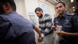الشرطة ترافق خالد قطينة، العربي من اسرائيل الذي دهس مشاة يهود في القدس، الى المحكمة المركزية في القدس، 16 ابريل 2015 (Miriam Alster/FLASH90)