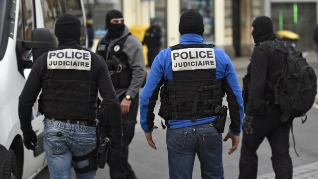 Members of the Raid, a special intervention unit of the French police, patrol in the northern Paris suburb of Saint-Denis city center, on November 18, 2015, as French Police special forces raid an appartment, hunting those behind the attacks that claimed 129 lives in the French capital five days ago. At least one person was killed in an apartment targeted in the operation aimed at the suspected mastermind of the attacks, Belgian Abdelhamid Abaaoud, and police had been wounded in the shootout.   AFP PHOTO / LIONEL BONAVENTURE