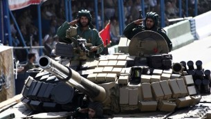 جنود إيرانيون داخل دبابة خلال المسيرة العسكرية السنوية في ذكرى حرب ايران مع العراق في طهران، 22 سبتمبر 2014 (Behrouz Mehri/AFP)