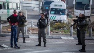 صورة توضيحية لقوات الامن الإسرائيلية توقف شاب فلسطيني عند مدخل مخيم شعفاط في القدس الشرقية، 2 ديسمبر 2015 (Hadas Parush/Flash90)