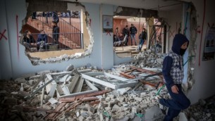 فلسطينيون يتفقدون الأضرار في منزل بهاء عليان، الذي قامت السلطات الإسرائيلية بهدمه في حي جبل المكبر في القدس الشرقية، ضمن الإجراء العقابي الذي تتبعه إسرائيل على هجمات ضد الإسرائيليين، 4 يناير، 2016. (Hadas Parush/Flash90)