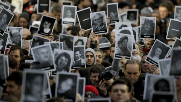 People hold up pictures of those who died in the AMIA Jewish center bombing that killed 85 people as they commemorate the attack's 22nd anniversary in Buenos Aires, Argentina, July 18, 2016. AP Photo/Natacha Pisarenko