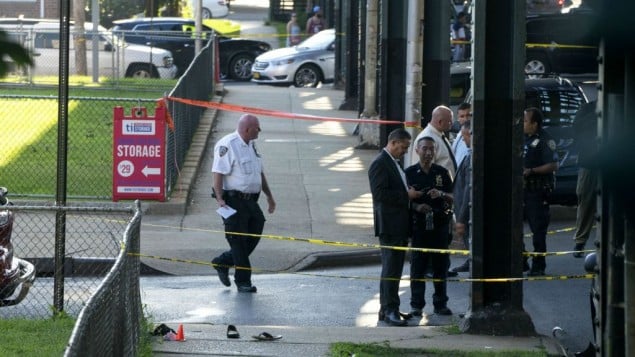 Sandals mark the crime scene, Saturday, Aug. 13, 2016, not far from the Al-Furqan Jame Masjid Mosque in the Ozone Park neighborhood of Queens, New York, where the leader of a New York City mosque and an associate were fatally shot in a brazen daylight attack. (AP Photo/Craig Ruttle) Sandals mark the crime scene, Saturday, Aug. 13, 2016, not far from the Al-Furqan Jame Masjid Mosque in the Ozone Park neighborhood of Queens, New York, where the leader of a New York City mosque and an associate were fatally shot in a brazen daylight attack. (AP Photo/Craig Ruttle)