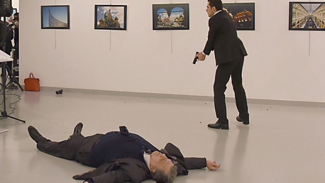 This picture taken on December 19, 2016 shows Andrey Karlov (L), the Russian ambassador to Ankara, lying on the floor after being shot by a gunman (R) during an attack during a public event in Ankara.
A gunman crying "Aleppo" and "revenge" shot Karlov while he was visiting an art exhibition in Ankara on December 19, witnesses and media reports said. The Turkish state-run Anadolu news agency said the gunman had been "neutralised" in a police operation, without giving further details. / AFP PHOTO / Sozcu daily / Yavuz Alatan / Turkey OUT