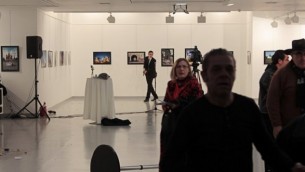صورة تم إلتقاطها في 19 ديسمبر، 2016 في أنقرة تظهر الضيوف يغادرون غاليري في الوقت الذي لوح فيه مسلح بمسدسه خلال هجوم إطلاق نار على السفير الروسي لدى تركيا أندريه كارلوف.  (AFP/ Hurryet/Hasim KILIC)