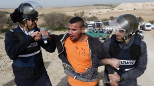 الشرطة الإسرائيلية تعتقل شابا بدويا خلال احتجاجات ضد هدم المنازل في 18 يناير، 2017، في قرية أم الحيران البدوية الغير معترف بها في النقب. (AFP Photo/Ahmad Gharabli)