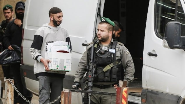 صورة توضيحية: القوات الإسرائيلية في قرية الرام في الضفة الغربية خلال إغلاق مكاتب استُخدمت كما زُعم من قبل السلطة الفلسطينية لتتبع بيع أشخاص من سكان القدس الشرقية أراض لليهود، 14 مارس، 2017. (AFP Photo/Ahmad Gharabli) صورة توضيحية: القوات الإسرائيلية في قرية الرام في الضفة الغربية خلال إغلاق مكاتب استُخدمت كما زُعم من قبل السلطة الفلسطينية لتتبع بيع أشخاص من سكان القدس الشرقية أراض لليهود، 14 مارس، 2017. (AFP Photo/Ahmad Gharabli)