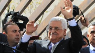 رئيس السلطة الفلسطينية محمود عباس يحيي مناصريه بعد رحلة إلى العاصمة الأمريكية واشنطن، 20 مارس، 2014، في مدينة رام الله بالضفة الغربية. (Issam Rimawi/Flash90)