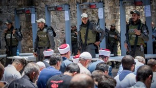 مسؤولو الوقف يقودون صلاة المسلمين خارج المسجد الأقصة في البلدة القديمة في القدس في 16 يوليو / تموز. قال مسؤولو الأوقاف  للمصلين المسلمين أن لا يدخلون المسجد عن طريق كاشفات معدنية مثبتة من قبل إسرائيل لأغراض أمنية بعد الهجوم في 14 يوليو / تموز والذي فيه ثلاثة عرب إسرائيليين ظهروا في ساحة المسجد وقتلوا اثنين من ضباط حرس الحدود الإسرائيليين. (Yonatan Sindel/Flash90)