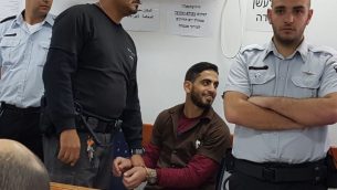 عمر العبد يبتسم في محكمة يهودا العسكرية قبل الحكم عليه، 15 فبراير 2018 (Courtesy)