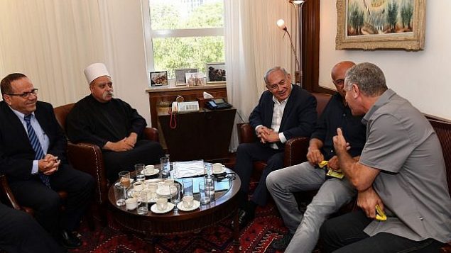 رئيس الوزراء بينيامين نتنياهو (وسط الصورة) يلتقي بالشيخ موفق طريف، الزعيم الروحي للطائفة الدرزية في إسرائيل، ووزير الاتصالات أيوب قرا (يسار الصورة) وزعماء دروز آخرين في مكتبه في القدس لمناقشة قانون ’الدولة القومية’ في 27 يوليو، 2018. (Kobi Gideon/GPO/Flash90)