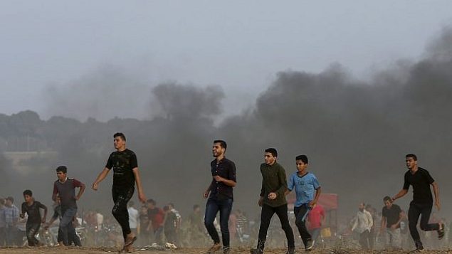 متظاهرون بالقرب من الحدود مع قطاع غزة مع إسرائيل شرقي خان يونس، جنوب قطاع غزة، الجمعة، 19 أكتوبر، 2018. (AP Photo/Adel Hana)
